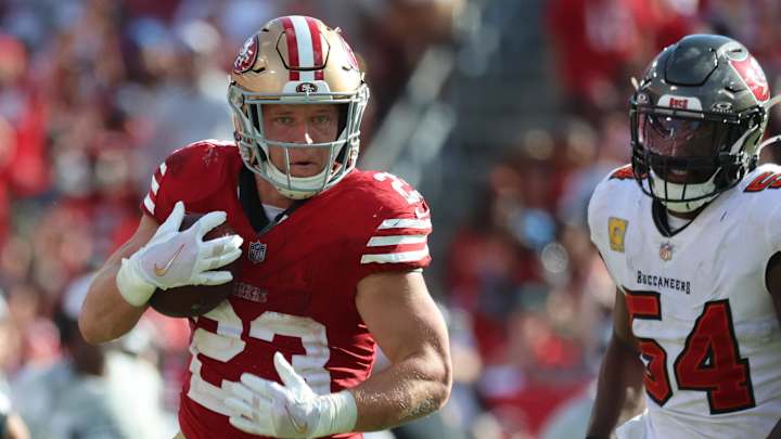 Nov 10, 2024; Tampa, Florida, USA; San Francisco 49ers running back Christian McCaffrey (23) catches the ball over Tampa Bay Buccaneers linebacker Lavonte David (54) during the second half at Raymond James Stadium. Mandatory Credit: Kim Klement Neitzel-Imagn Images