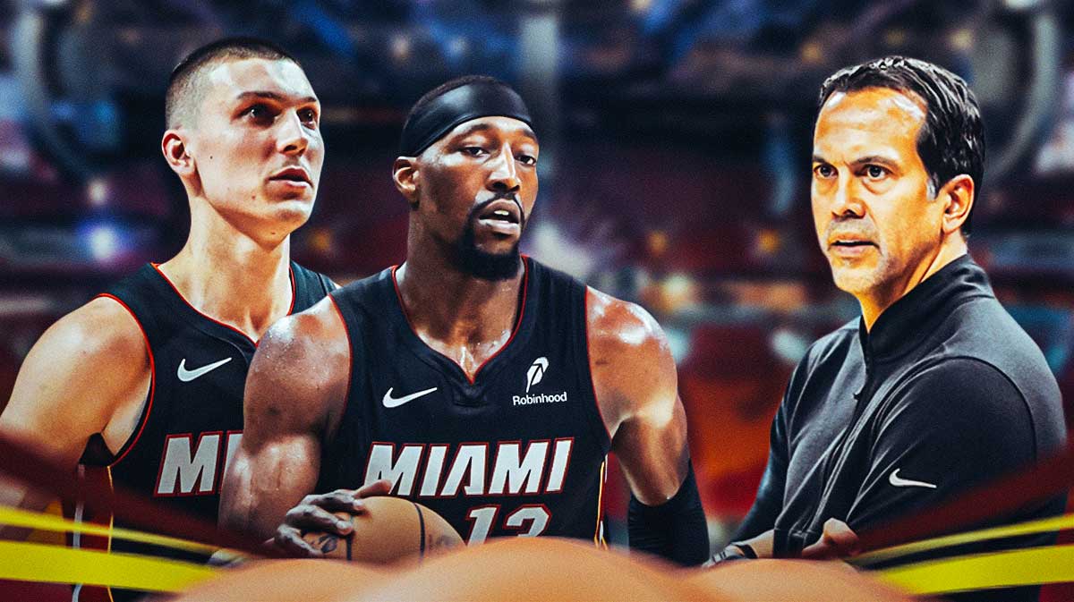 Miami Heat stars Tyler Herro and Bam Adebayo looking at Erik Spoelstra in front of Kaseya Center.